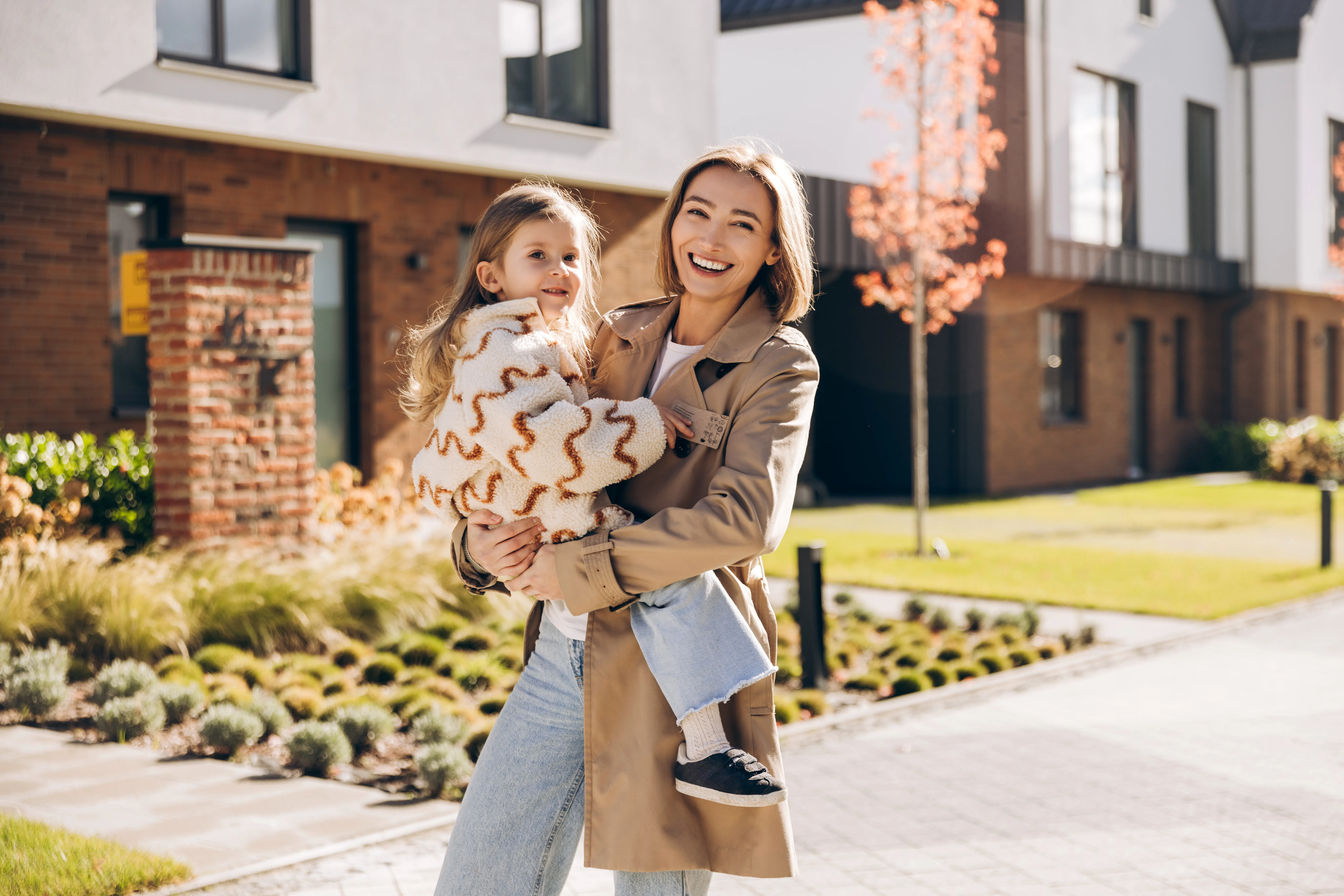 A grandmother, mother, and daughter smiling together outdoors